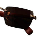 Brown sunglasses with gold frames on a white background