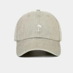 Beige cap with a palm tree logo on a white background