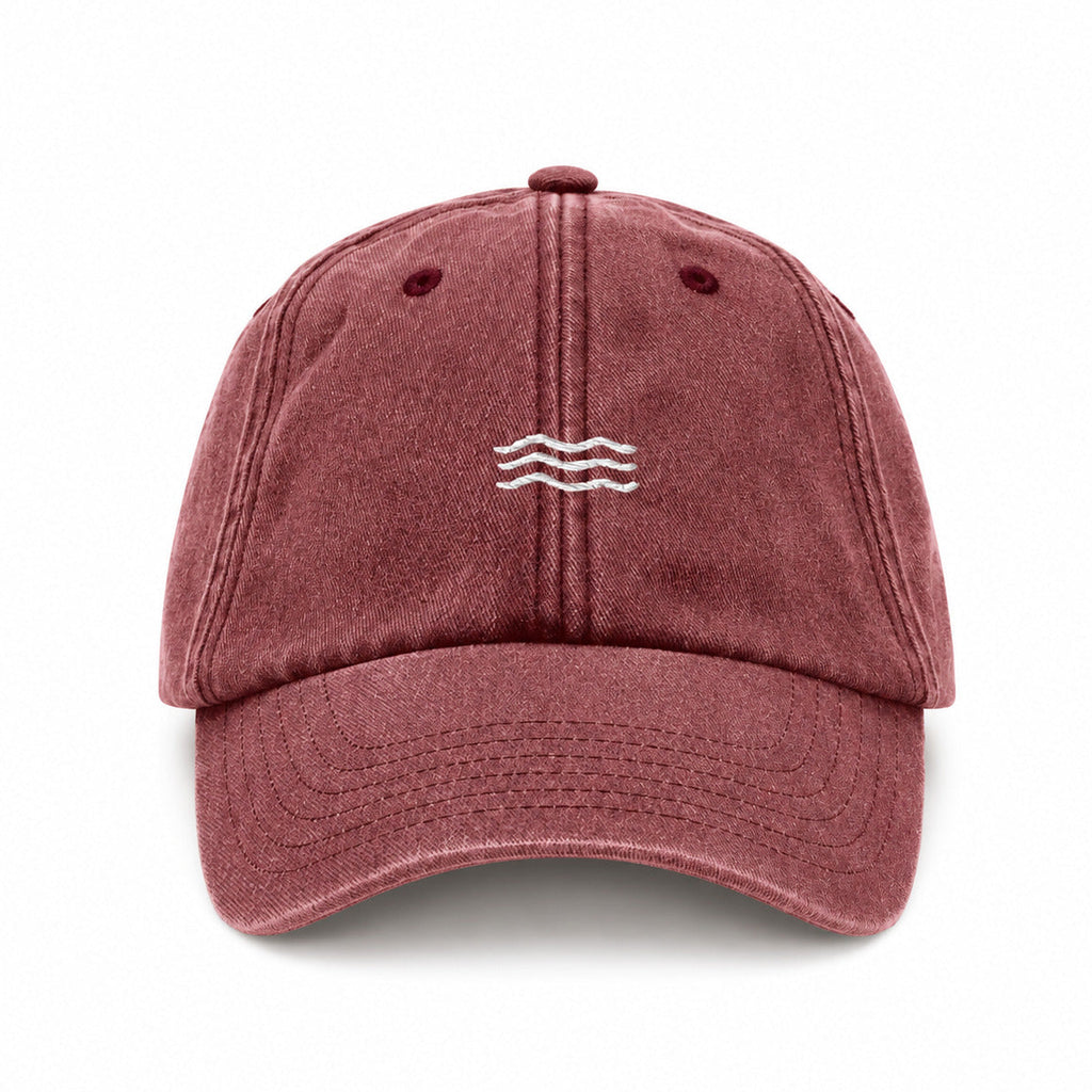 Maroon baseball cap with a small logo on a white background