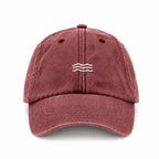 Maroon baseball cap with a small logo on a white background