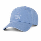 Blue cap with 'The Good Vibes Only' text on a white background