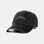 Black cap with mountain design on a light gray background