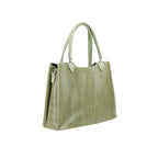 Green handbag with textured surface on a white background