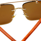 Sunglasses with gold frame and brown lenses on a white background