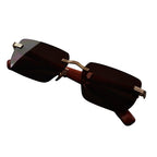 Sunglasses with gold frames and dark lenses on a white background