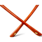 Crossed wooden sticks with gold accents on a white background