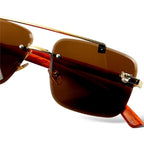 Sunglasses with gold frame and brown lenses on a white background