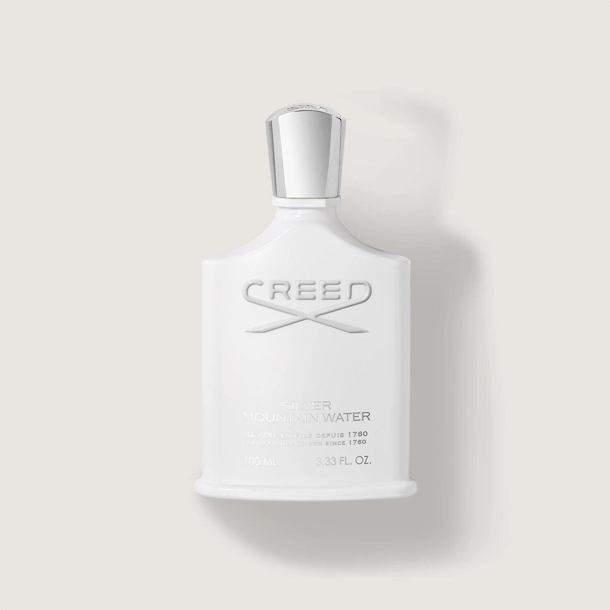 Creed eau de toilette bottle on a light gray background