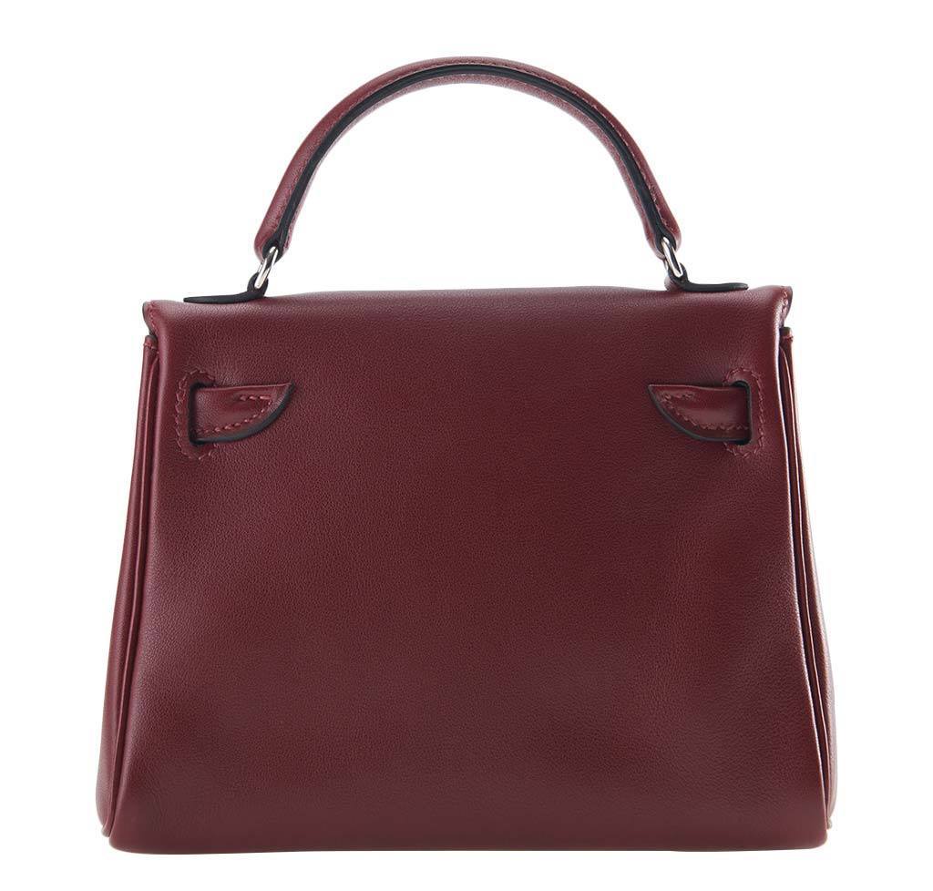 Brown leather handbag with a visible brand logo on a white background