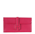 Red clutch bag with a buckle on a white background