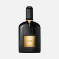 Black and gold Tom Ford perfume bottle on a light gray background