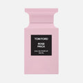 Pink Tom Ford perfume bottle with black label on a white background
