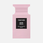 Pink Tom Ford perfume bottle with black label on a white background