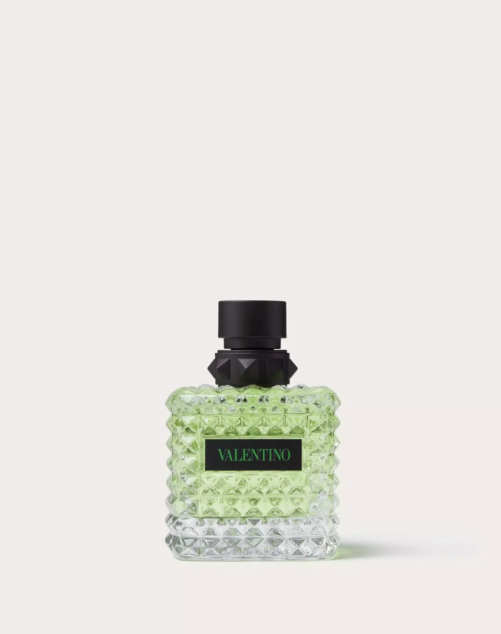 Perfume bottle with black cap and green body on a white background