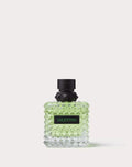 Perfume bottle with black cap and green body on a white background