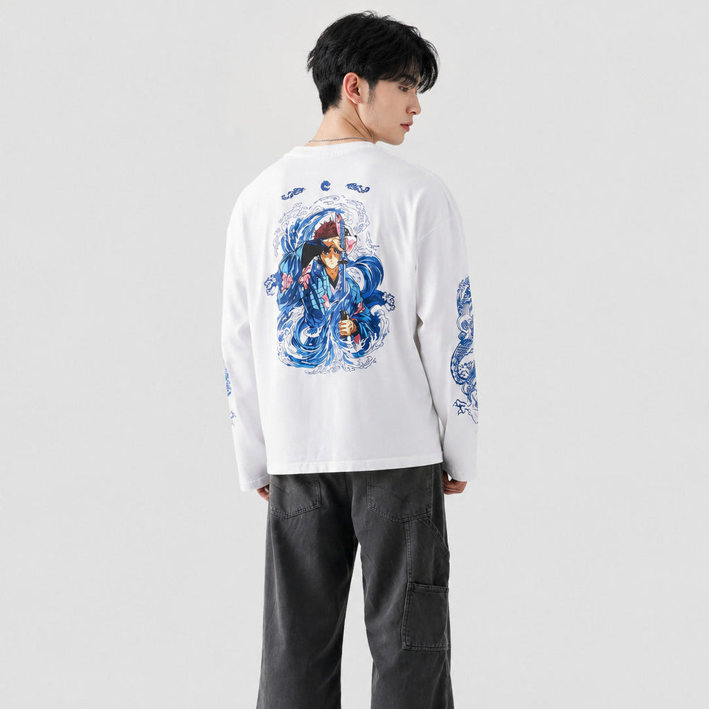 Person wearing a white long-sleeve shirt with blue graphic design on a plain background