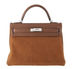 Brown handbag with a silver clasp on a white background