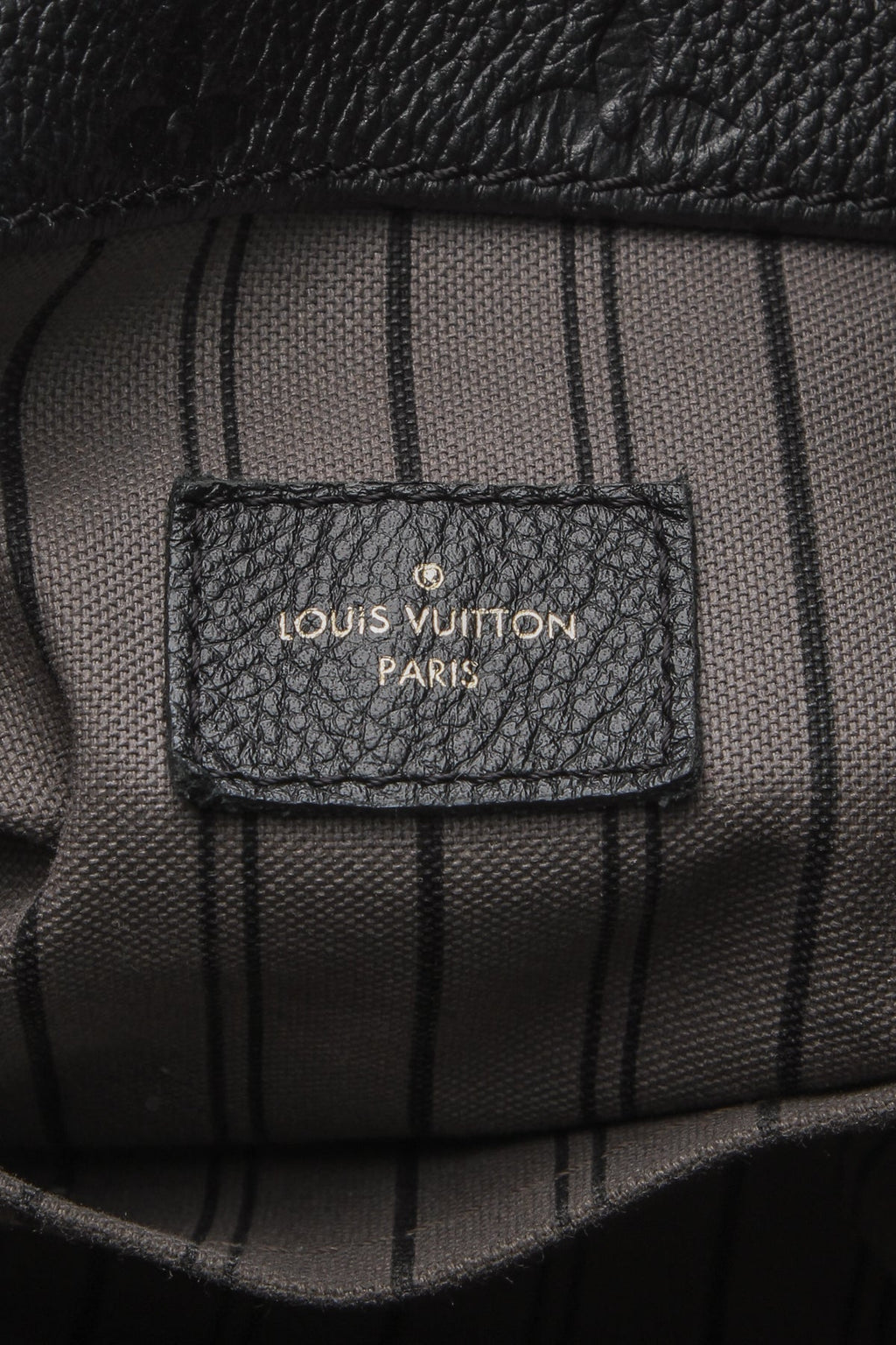 A view of the bag’s sturdy base, showing the protective metal feet.