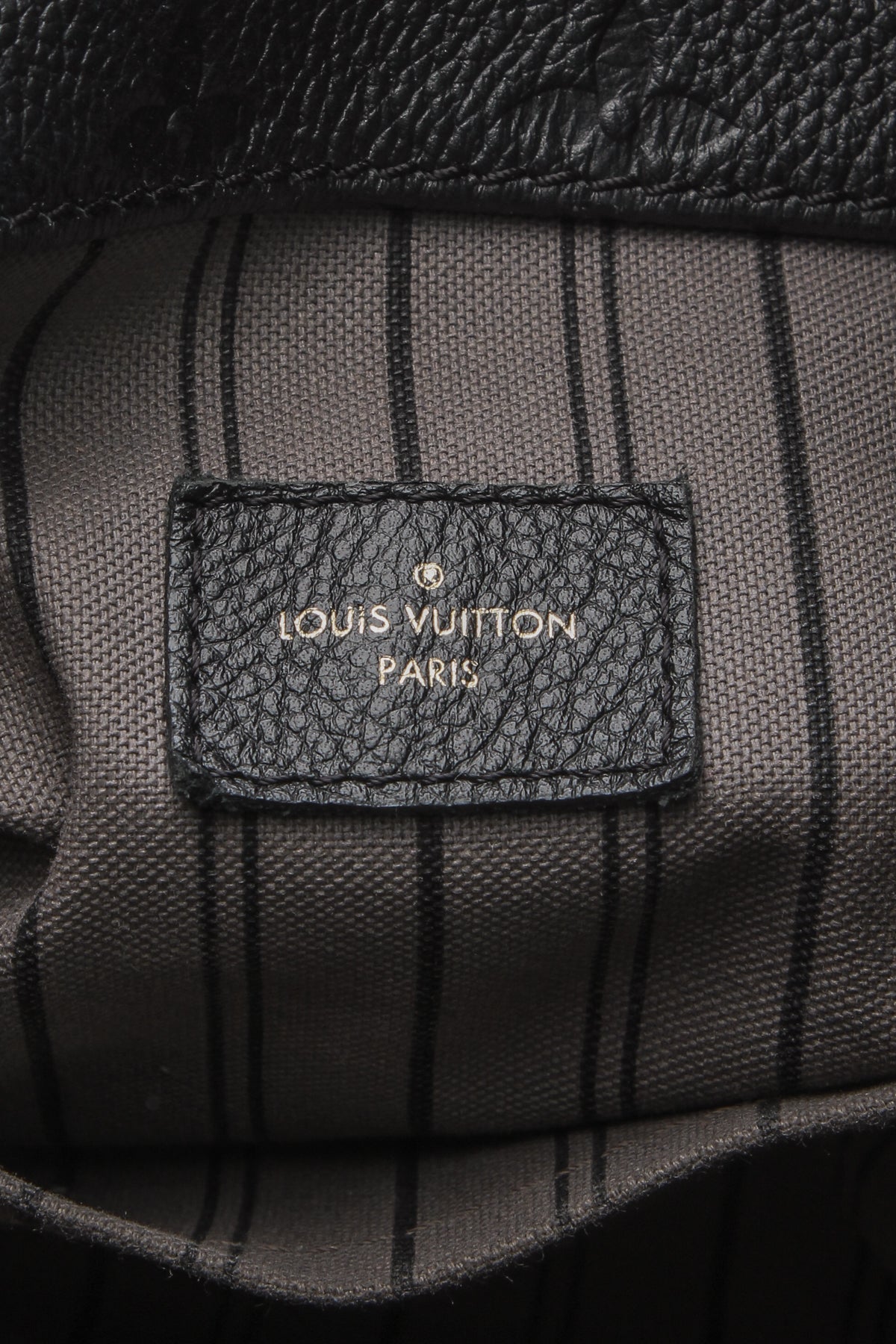 A view of the bag’s sturdy base, showing the protective metal feet.