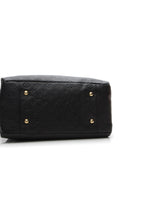 The side view of the bag when it is empty, showing its relaxed silhouette