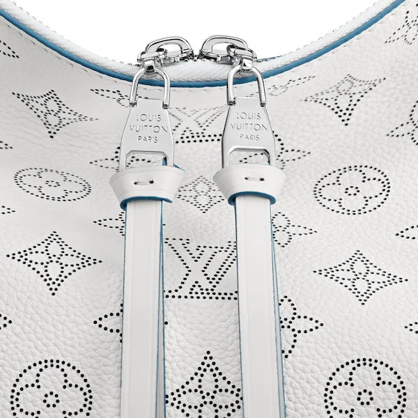 The bag being worn with its detachable strap over the shoulder