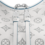 The bag being worn with its detachable strap over the shoulder
