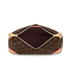 The bag carried by its chain, styled for evening