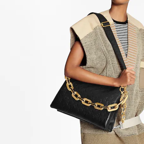 A detailed shot of the gold-tone hardware on the bag's strap