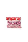 The Louis Vuitton Escale Kirigami pochette displayed on a surface