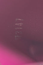 An image of the smooth fuchsia leather lining inside