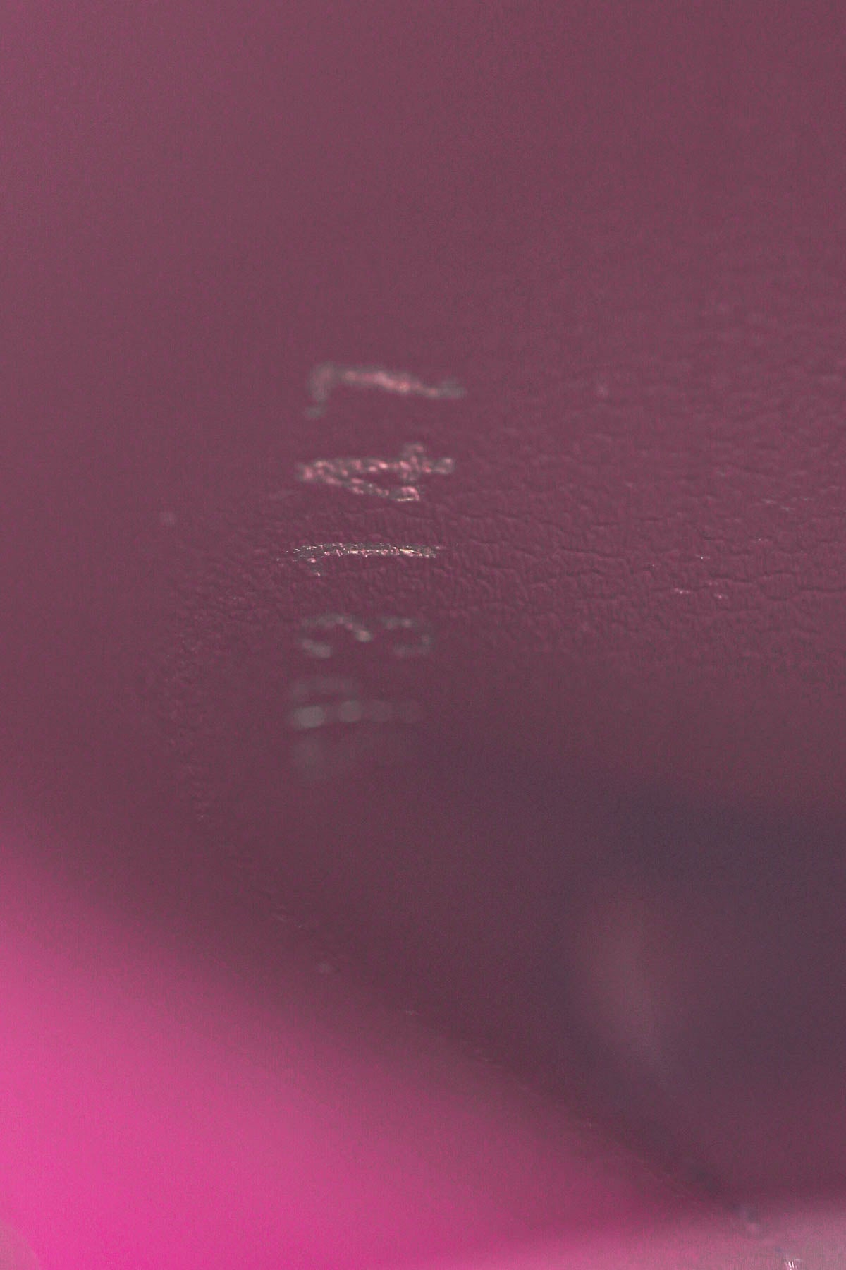 An image of the smooth fuchsia leather lining inside