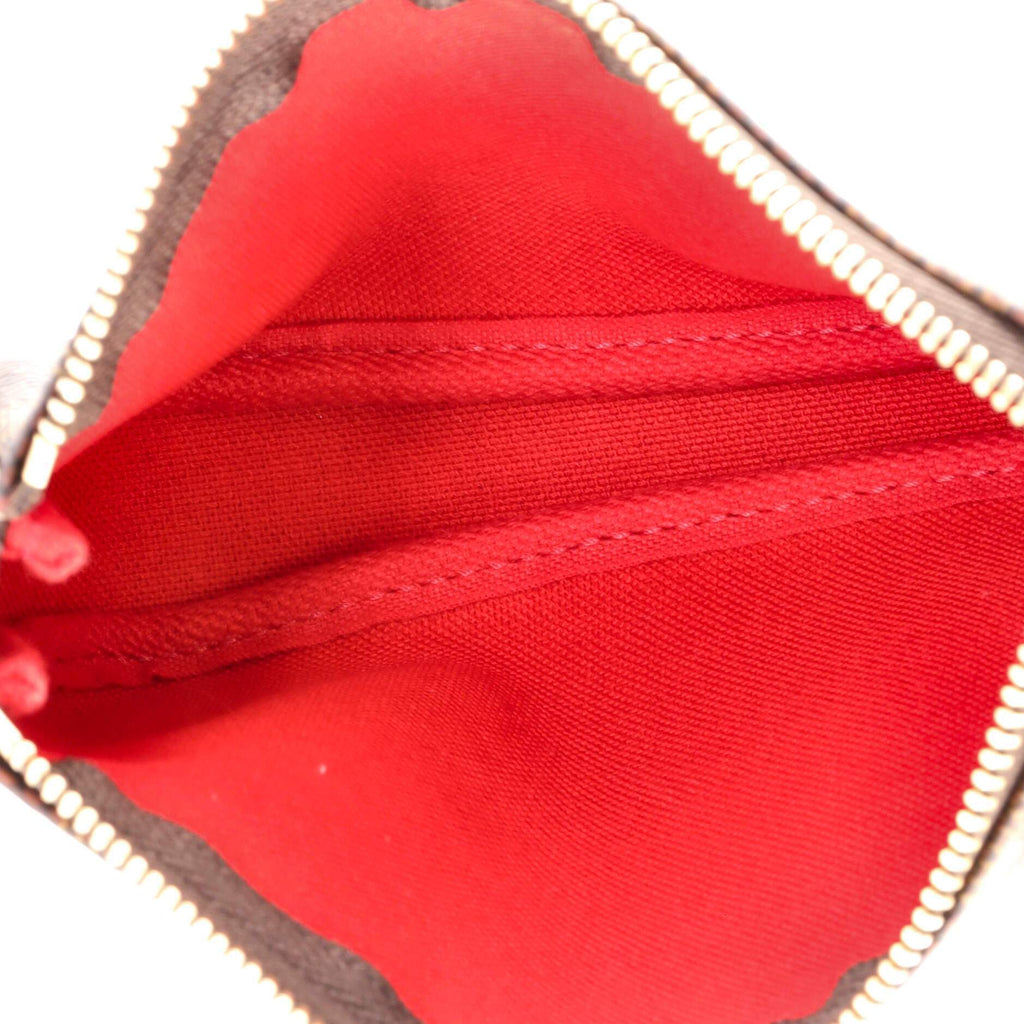 The pouch being held in a hand, showing its compact size