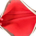 The pouch being held in a hand, showing its compact size