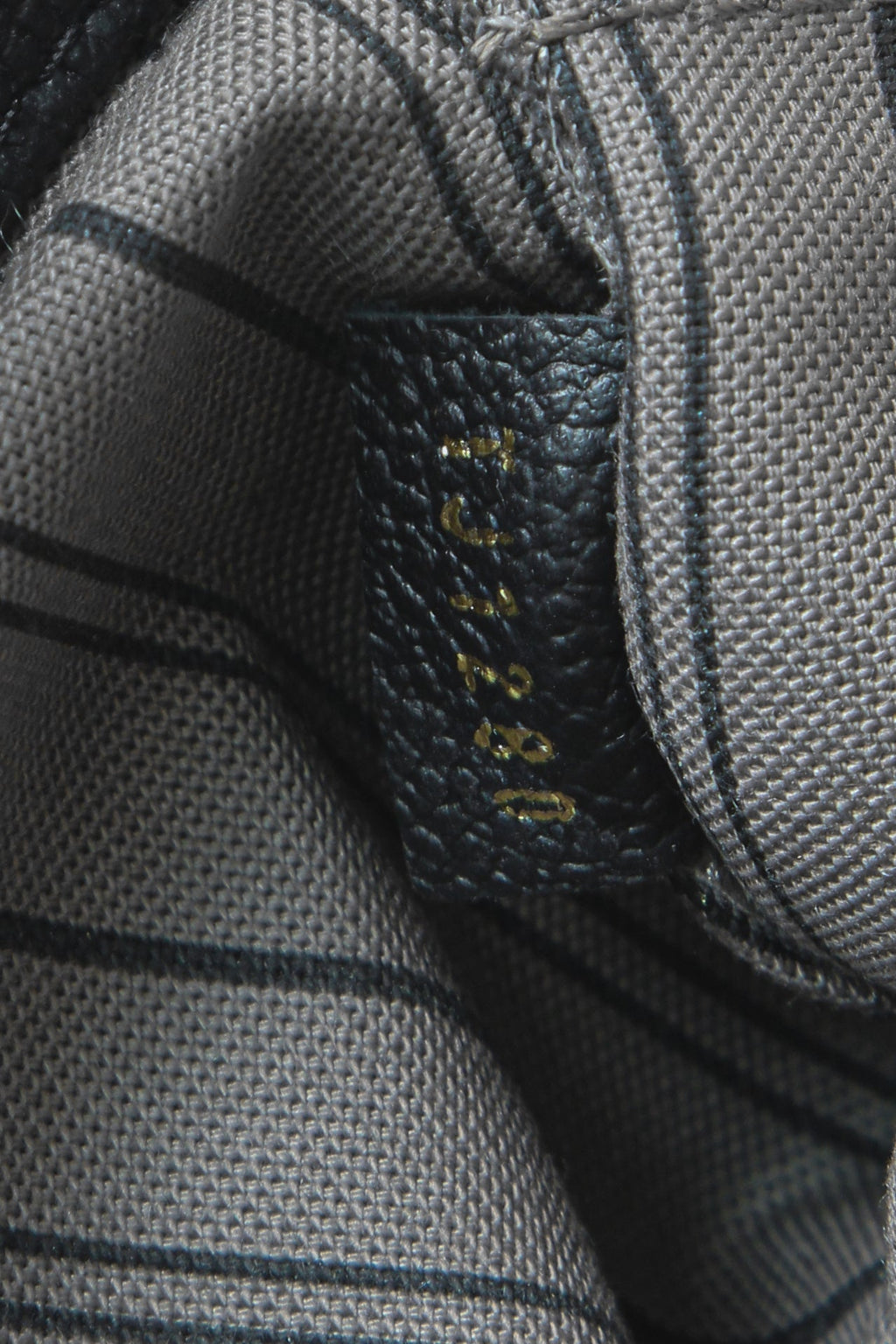 A close-up of the braided top loops for carrying the bag