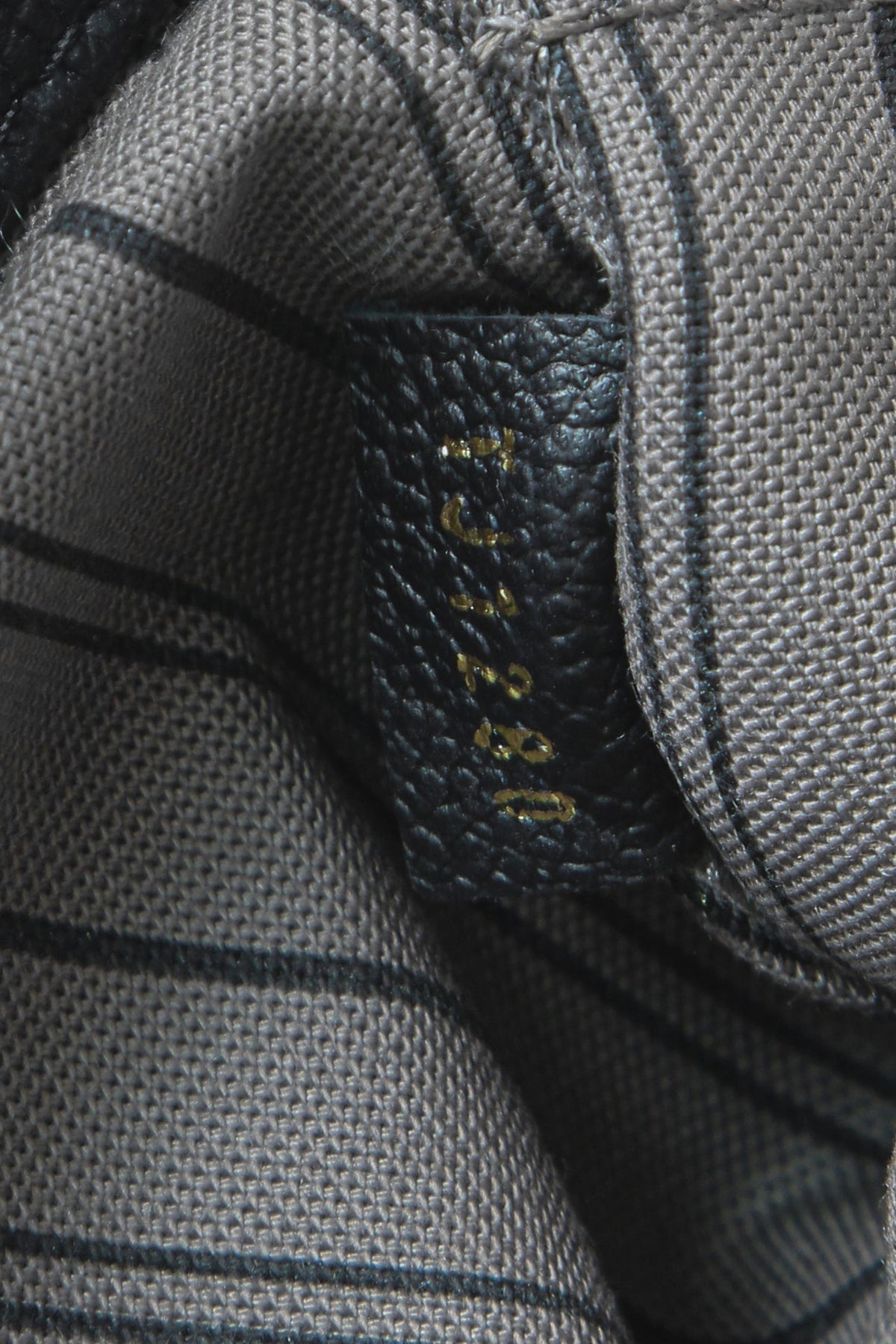 A close-up of the braided top loops for carrying the bag