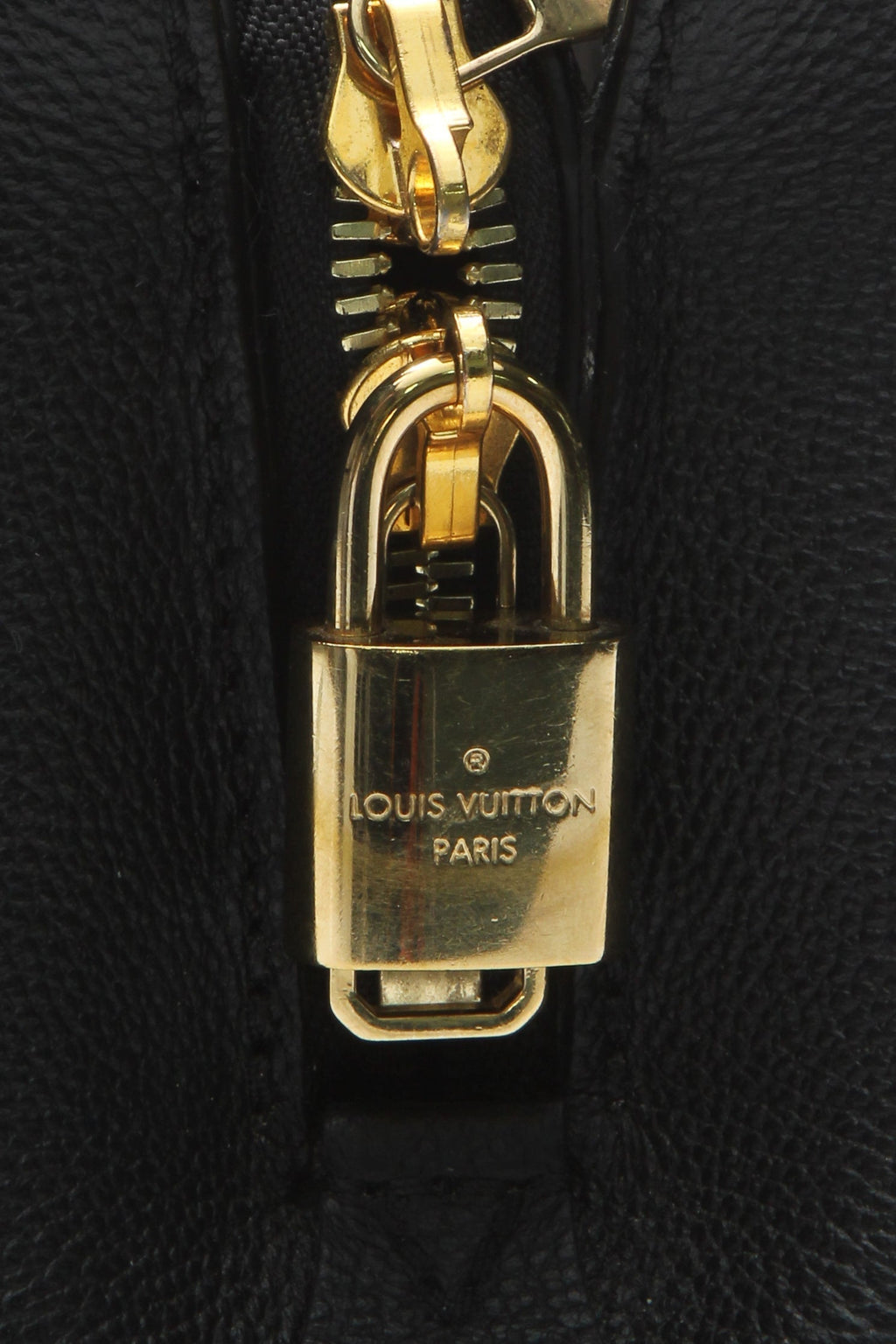 A close-up of the stitching that outlines the monogram pattern