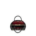 The bag is carried on the arm, showing its elegant fit