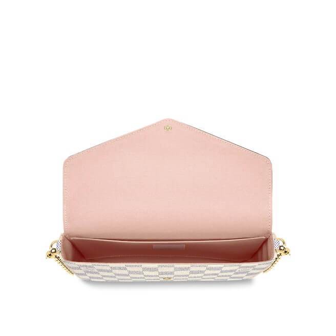 The pouch worn with its removable gold-tone chain over the shoulder