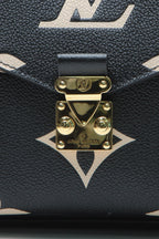 The back of the bag, showing the flat pocket and leather trim