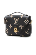 The bag carried on the forearm, highlighting its top handle carry option.
