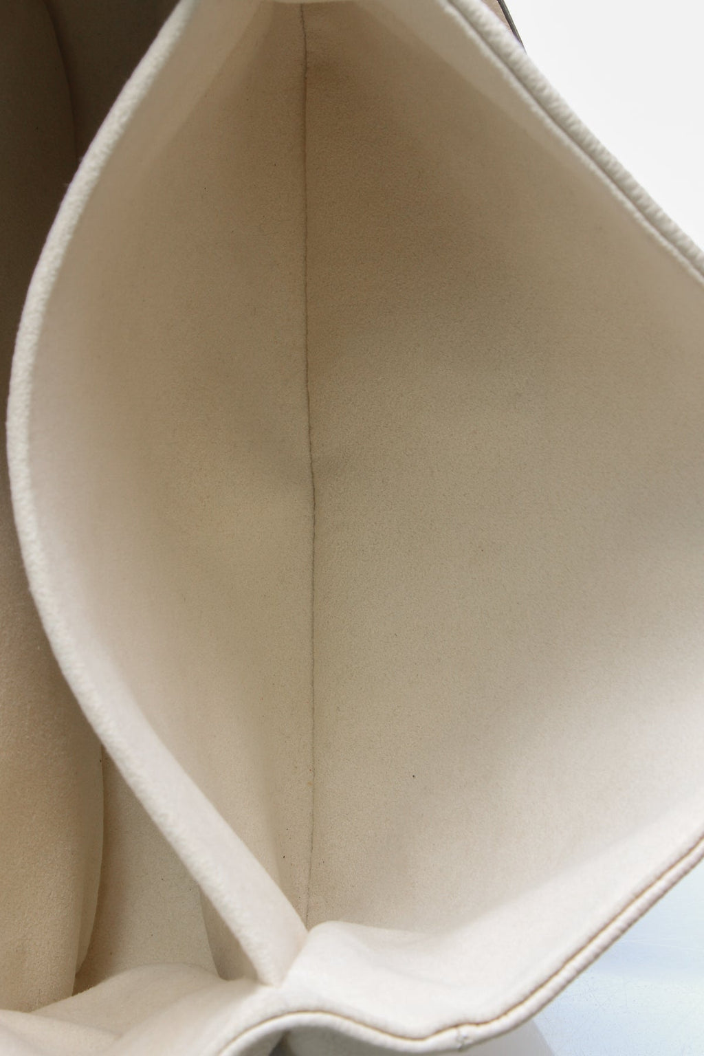 Front view of the Louis Vuitton Pochette Metis in Cream and Dove Bicolor Empreinte leather