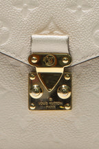 A detailed shot of the gold-tone hardware and push-lock closure