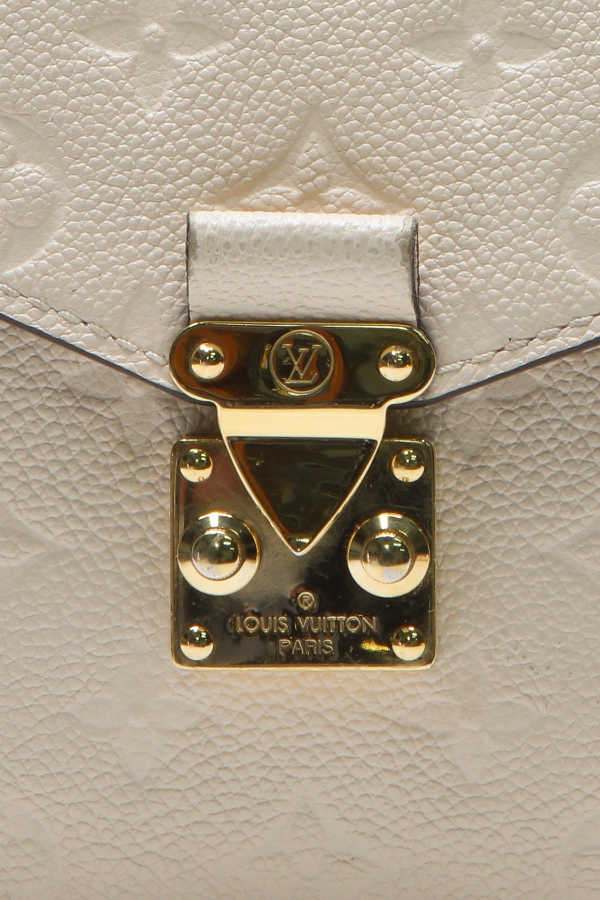 A detailed shot of the gold-tone hardware and push-lock closure
