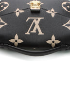A close-up of the iconic gold-tone push-lock