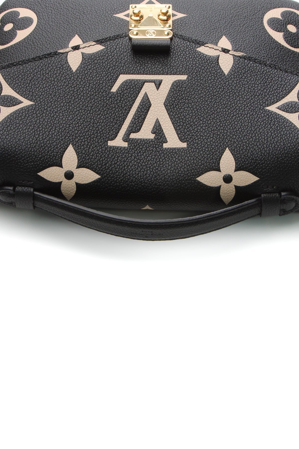 A close-up of the iconic gold-tone push-lock