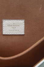 A close-up of the bag's iconic gold-color push-lock
