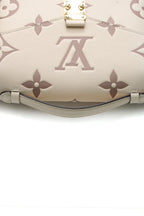 A close-up of the bag's iconic gold-color push-lock