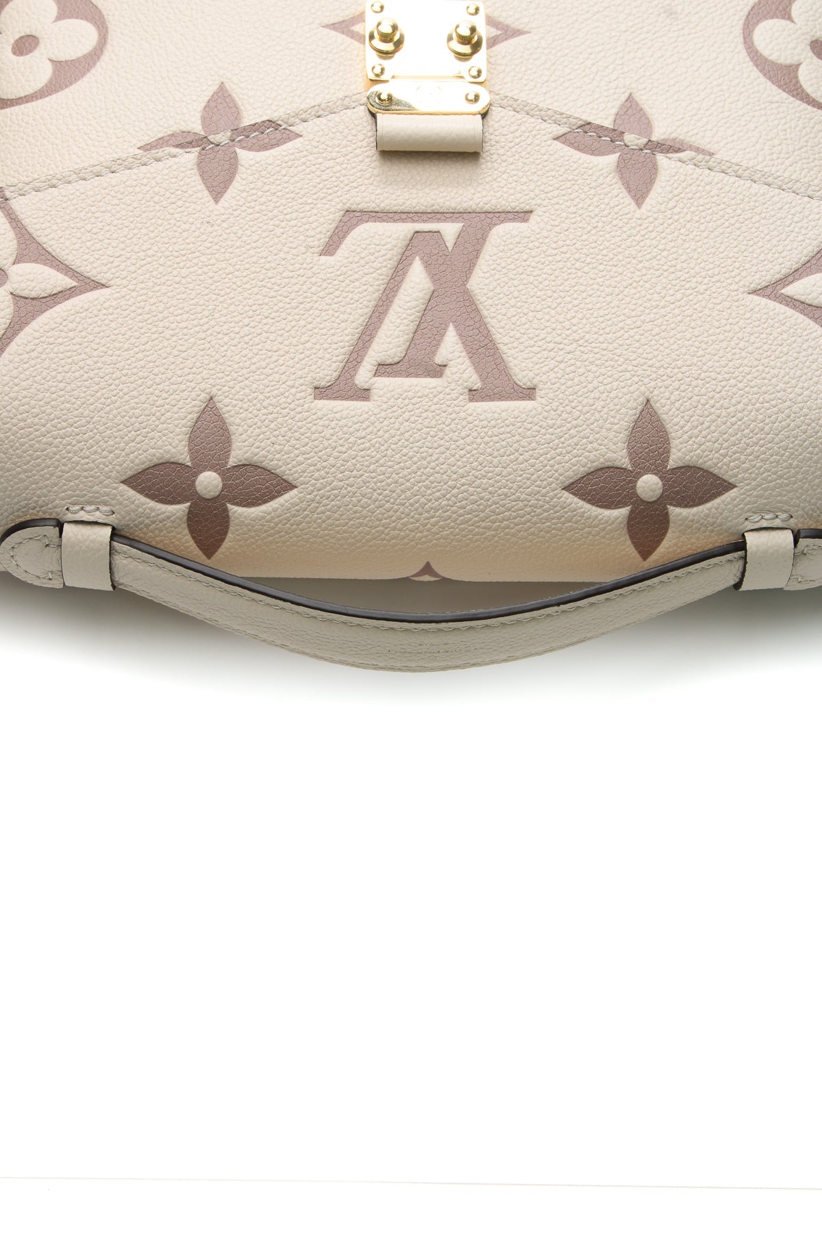 A close-up of the bag's iconic gold-color push-lock