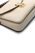 A close-up image showing the embossed Monogram pattern and leather texture