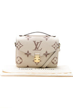 The bag carried on the forearm, highlighting its top handle carry option